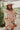 Frontal view of the Cabin Fever Sweater that features a cream knit material, a V neckline, a long sleeve, a topaz multi-pattern design, and an oversized fit.