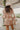 Back view of the Cabin Fever Sweater that features a cream knit material, a V neckline, a long sleeve, a topaz multi-pattern design, and an oversized fit.