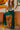 Frontal view of the With The Flow Pants that features a green colored velvet material, a high-rise fit, a side zipper, and a wide leg fit.