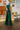 Side view of the With The Flow Pants that features a green colored velvet material, a high-rise fit, a side zipper, and a wide leg fit.