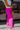 Side view of the Midtown Minute Pants that features a magenta colored material, a high-rise fit, a front button and zipper closure, side pockets, a pleated front, two back pockets, and a wide leg fit.