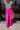  Frontal view of the Midtown Minute Pants that features a magenta colored material, a high-rise fit, a front button and zipper closure, side pockets, a pleated front, two back pockets, and a wide leg fit.