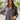 Frontal view of the Bare With Me Top that features a charcoal grey gauze material, a V neckline, a button-up front, a long cuffed sleeve, raw hemlines through out, and side pockets.