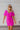 Frontal view of the Sitting Pretty Mini Dress that features a magenta colored chiffon material, a surplice neckline, short sleeves, a surplice front, a back zipper, and a mini length
