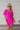 Frontal view of the Sitting Pretty Mini Dress that features a magenta colored chiffon material, a surplice neckline, short sleeves, a surplice front, a back zipper, and a mini length