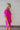 Side view of the Sitting Pretty Mini Dress that features a magenta colored chiffon material, a surplice neckline, short sleeves, a surplice front, a back zipper, and a mini length