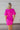 Back view of the Sitting Pretty Mini Dress that features a magenta colored chiffon material, a surplice neckline, short sleeves, a surplice front, a back zipper, and a mini length