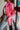Side view of the Seasons Change Jacket that features a pink colored corduroy material, a collar and lapel neckline, a two button front closure, a long sleeve, two front pockets, and a back slit.