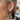 Close up view of model wearing the All Season Long Earrings which features embellished green and gold beads, floral pattern on a closed hoop.