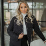 Front view of The Midnight Fun Jacket features black coloring fabric, diamond stitched pattern, two front buttoned chest pockets, black button up with a collared neckline, and long sleeves with buttoned cuffs.