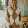 Front view of The Classic And Cozy Sweater features brown knit fabric and cream sherpa fabric, diamond shaped pattern, cable knit hem, v-neckline, and long balloon sleeves with cable knit cuffs. 