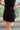 Frontal view of the Twist and Shout Mini Skirt that features a black colored suede material, a high-rise fit, layered fringe detailing through out, a mini length, and a side zipper closure.