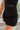 Frontal view of the Twist and Shout Mini Skirt that features a black colored suede material, a high-rise fit, layered fringe detailing through out, a mini length, and a side zipper closure.