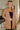 Frontal view of the Down To Business Blazer In Taupe that features a taupe colored material, a collar and lapel neckline, a front button closure, a long sleeve, two front pockets, and a back slit.