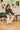 Frontal view of the Nothing On You Top that features a black material, a white plaid pattern, a collar neck, a button-up front, long sleeves, two front pockets, a front knot detail at the hemline, and an elastic hemline in the back.