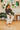 Frontal view of the Nothing On You Top that features a black material, a white plaid pattern, a collar neck, a button-up front, long sleeves, two front pockets, a front knot detail at the hemline, and an elastic hemline in the back.