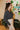 Side view of the Nothing On You Top that features a black material, a white plaid pattern, a collar neck, a button-up front, long sleeves, two front pockets, a front knot detail at the hemline, and an elastic hemline in the back.