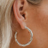 The Silver and Sleek Earring is a hoop style earring, featuring twisted textured design.