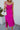 Front view of model wearing the Let's Dance Midi Dress, which features a fuchsia satin material, a cowl neckline, a sleeveless design with thin adjustable straps, a side slit, and a midi length.