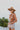 The Pretty In Paisley Hat is a wide brim hat featuring a camel colored fabric featuring a brown belt with a black and white paisley design finished with adjustable ties within for adjusted fit.