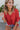 Frontal view of the Best Of My Love Top that features a deep V neckline, a half sleeve with a ruffle detail, a ruched front with adjustable ties, a high-low design, and a flowy fit.