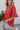 Side view of the Best Of My Love Top that features a deep V neckline, a half sleeve with a ruffle detail, a ruched front with adjustable ties, a high-low design, and a flowy fit.