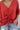Frontal view of the Best Of My Love Top that features a deep V neckline, a half sleeve with a ruffle detail, a ruched front with adjustable ties, a high-low design, and a flowy fit.