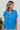 Frontal view of the Irreplaceable Top that features a royal blue material, a round neckline with a ruffle detail, a cut-out at the chest with adjustable ties, a short smocked sleeve, and a flowy fit.