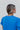 Back view of the Irreplaceable Top that features a royal blue material, a round neckline with a ruffle detail, a cut-out at the chest with adjustable ties, a short smocked sleeve, and a flowy fit.