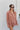 Frontal view of the Jump Start Top that features a marsala colored material, a collar neckline, a button-up front, a cuffed long sleeve, a front pocket a high-low design, and a flowy fit