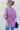 Back view of the Back In Session Top In Rose that features a rose colored material, a collar neckline, a button-up front, an oversized half sleeve, a high-low design, and a flowy fit.