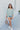 Frontal view of the Back In Session Top In Spruce that features a sage colored material, a collar neckline, a button-up front, an oversized half sleeve, a high-low design, and a flowy fit.