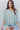 Frontal view of the Back In Session Top In Spruce that features a sage colored material, a collar neckline, a button-up front, an oversized half sleeve, a high-low design, and a flowy fit.