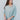Frontal view of the Back In Session Top In Spruce that features a sage colored material, a collar neckline, a button-up front, an oversized half sleeve, a high-low design, and a flowy fit.