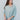 Frontal view of the Back In Session Top In Spruce that features a sage colored material, a collar neckline, a button-up front, an oversized half sleeve, a high-low design, and a flowy fit.