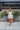 Frontal view of the Tulle Me About It Mini Dress that features a cream tulle material with a straight neckline, a sleeveless tiered design, a side zipper closure, and a mini length