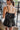 Back view of the Everlasting Love Crop Top that features black fabric, a straight neckline, a sleeveless design with thin adjustable straps, a back oversized bow detail, a side zipper closure, and a cropped fit.