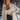 Frontal view of the Day Glow Top that features an ivory sheer chiffon material, a collar neckline, a button-up front, a long cuffed sleeve, and a flowy fit.