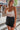 Frontal view of the Day Glow Tank Top that features an ivory sheer chiffon material, a cowl neckline, a sleeveless design with thin straps, an open tie back, and a cropped fit.