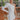 Frontal view of the Late Night Talk Dress that features white fabric, an asymmetrical neckline, a one shoulder long sleeve, a front slit, a side zipper closure, and a mini length.