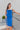 Frontal view of the Royalty Midi Dress that features a royal blue silk material, a sleeveless design with thin adjustable straps, a bustier design, a back zipper closure, and a midi length