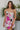 Frontal view of the Meet Me At The Disco Dress that features a multi-colored print, a V neckline, a sleeveless design with thin adjustable straps, a back zipper closure, and a mini length.