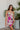 Frontal view of the Meet Me At The Disco Dress that features a multi-colored print, a V neckline, a sleeveless design with thin adjustable straps, a back zipper closure, and a mini length.