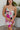 Frontal view of the Meet Me At The Disco Dress that features a multi-colored print, a V neckline, a sleeveless design with thin adjustable straps, a back zipper closure, and a mini length.