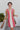 Frontal view of the All Caught Up Dress that features a multi-colored denim material, a square neckline, a sleeveless design with thick straps, a color block design, and a side zipper closure.