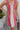 Frontal view of the All Caught Up Dress that features a multi-colored denim material, a square neckline, a sleeveless design with thick straps, a color block design, and a side zipper closure.