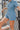 Frontal View of the Heading South Romper that features a blue colored material, a collar neckline, a short cuffed sleeve, a button-up front, two front pockets at the chest, a cinched waist, two side pockets, cuffed bottom hem, and two back pockets.