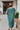 Back view of the Places To Be Midi Dress that features a soft tshirt material, a rounded neckline, a short sleeve, a midi length, side slits, a rounded hemline, and a flowy fit.
