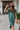 Frontal view of the Places To Be Midi Dress that features a soft tshirt material, a rounded neckline, a short sleeve, a midi length, side slits, a rounded hemline, and a flowy fit.
