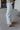 Side view of the Loretta Straight Leg Jeans that features a light wash denim, a swirl print design, two front pockets, a button and zipper closure, two back pockets, and a wide leg fit.